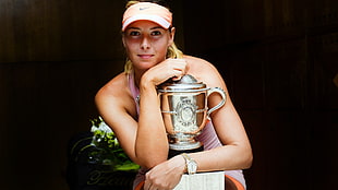 Maria Sharapova holding silver trophy