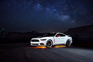 white Ford Mustang sports coupe on road