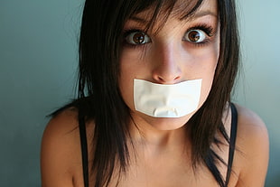 woman with white tape on mouth