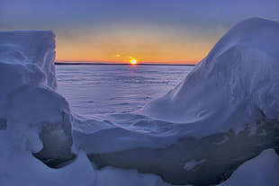 snow-covered landscape during sunset