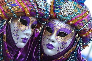 closed-up image of two purple and white party masks