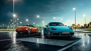 two orange and teal sports car parked on concrete ground
