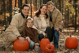 selective focus photography of couple with their children