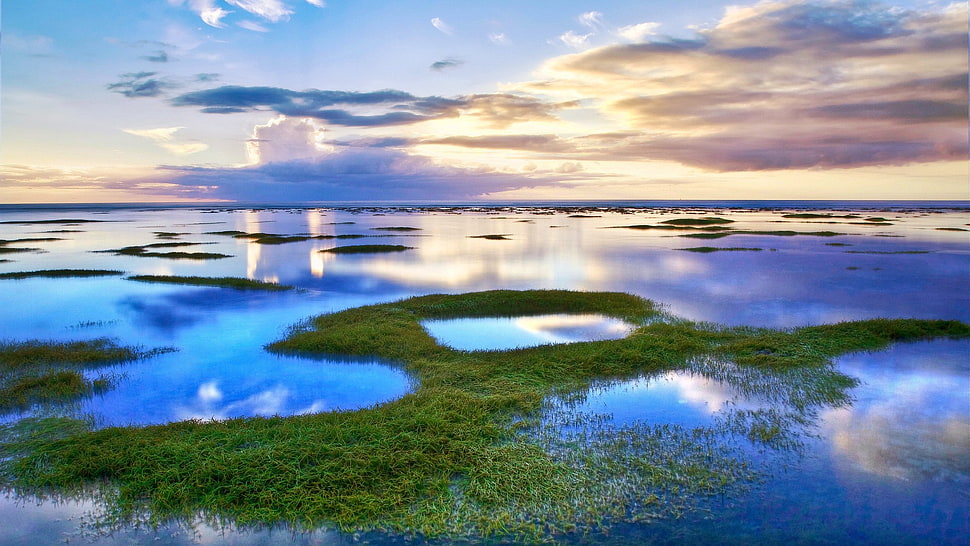 green island under gray clouds photo HD wallpaper