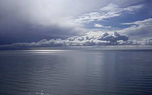 calm sea under white clouds during daytime HD wallpaper