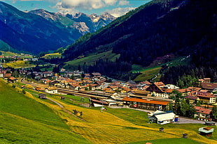 aerial view photo village near green grass hill, st anton, austria HD wallpaper