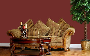 beige floral sofa with brown wooden frame with brown wooden center table