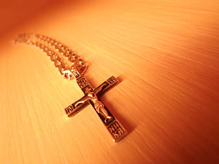 gold-colored crucifix pendant necklace