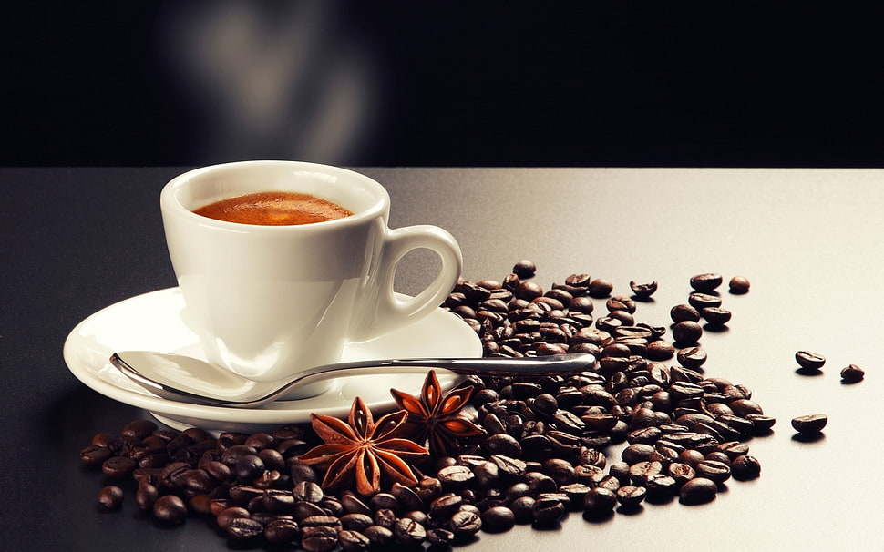 white teacup on plate beside spoon on coffee beans HD wallpaper