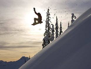 person in read jacket sweatshirt, white pants riding on snowboard during daytime HD wallpaper