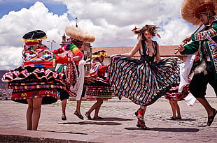 woman wearing a multicolored sleeveless dress while dancing