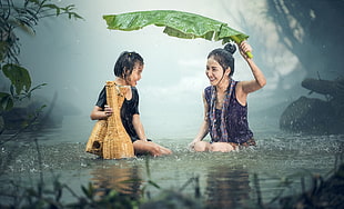 woman and child playing under the rain HD wallpaper