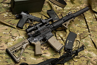 black and brown assault rifle with magazines and pistol