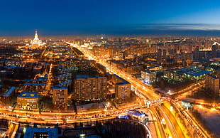aerial view of city buildings and roads at night time