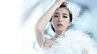 photo of woman wearing white feather and fur costume at daytime