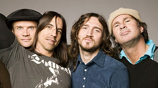 four men wearing long-sleeved shirts