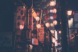 lighted paper lantern hanging on street