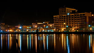 landscape photography of city buildings near body of water HD wallpaper