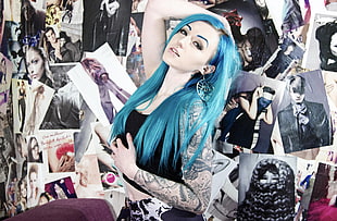 blue haired woman surrounded by posters