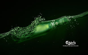 time lapse photography of Carlsberg bottle on water