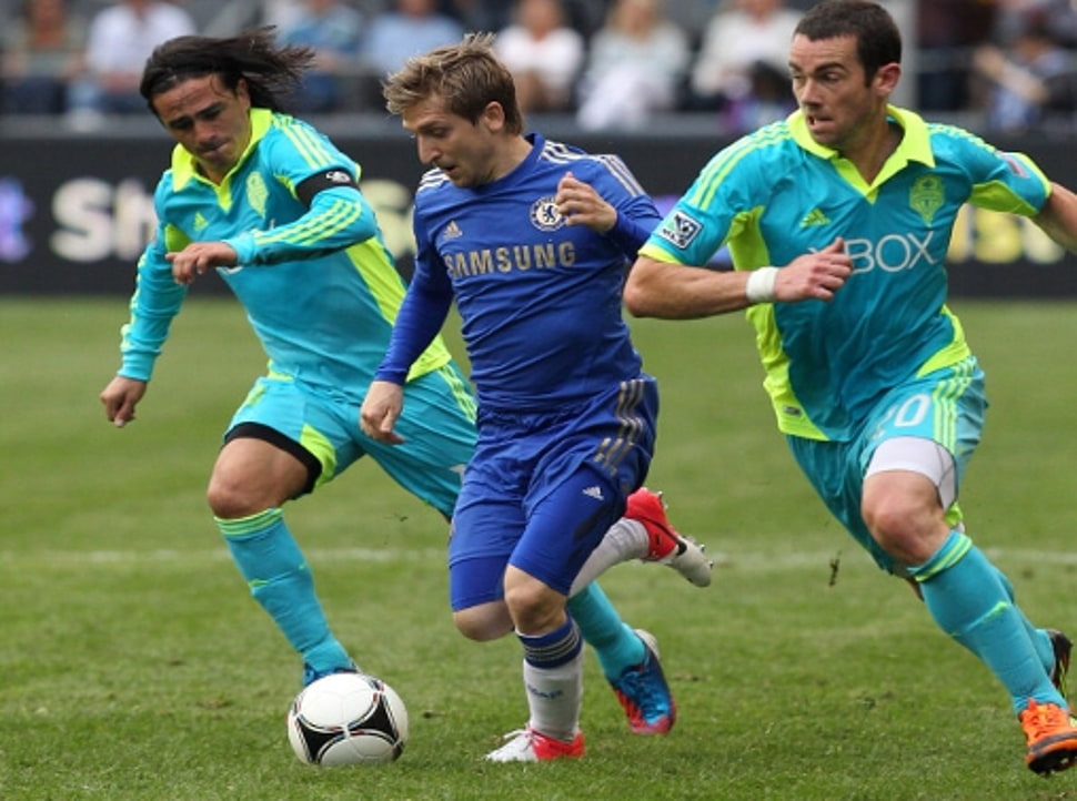 three soccer player on field during daytime HD wallpaper