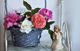 gray wicker basket with white and pink flowers
