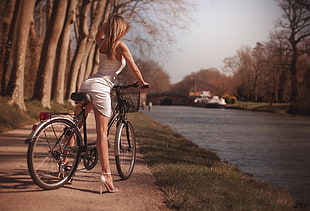 woman sitting on bike during daytime