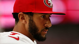 San Francisco 49ers player wearing red cap