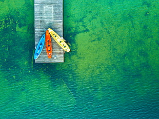 photo of three kayaks on dock