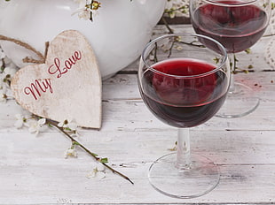 red wine on wine glass near my love heart pendant