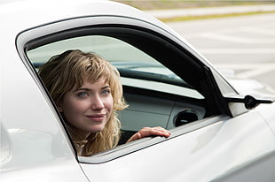 shallow focus photography of woman inside white car