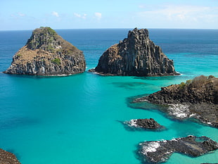 aerial photography of cliffs surrounded by body of water, fernando de noronha