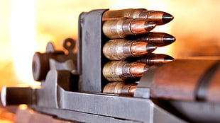 closeup photography of brass-colored bullets