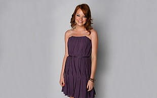 woman wearing purple strapless dress and smiling