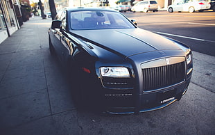 black Rolls Royce Phantom parked on road side at daytime