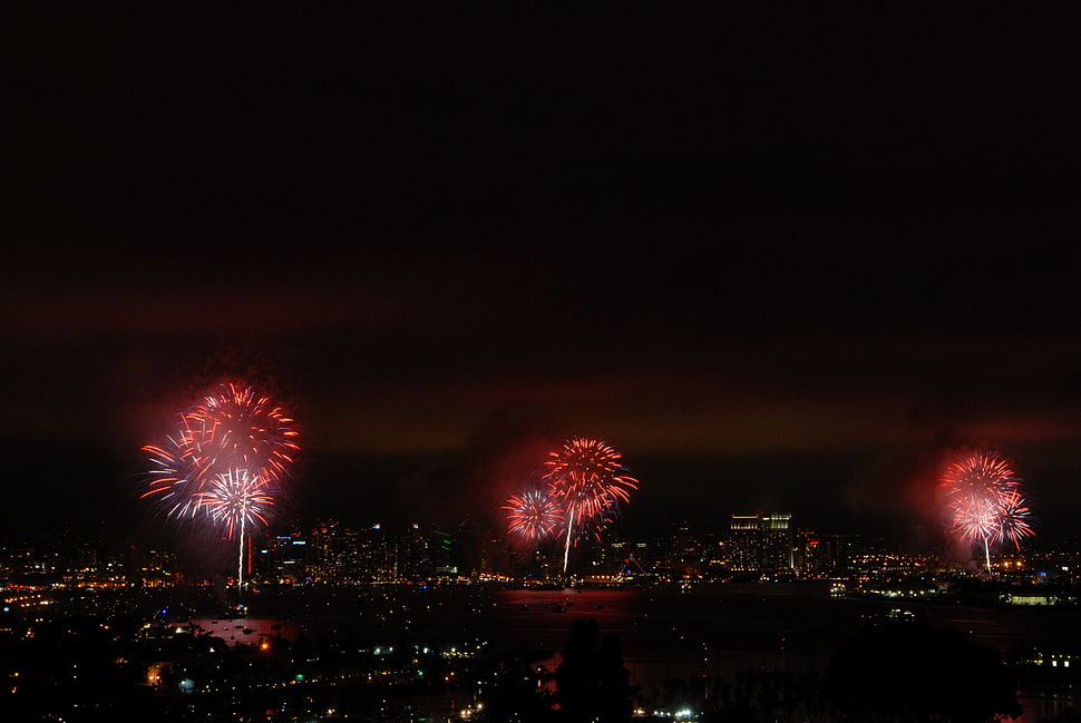 aerial photo of red fireworks in city HD wallpaper