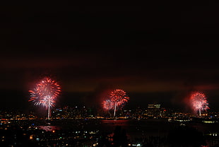 aerial photo of red fireworks in city