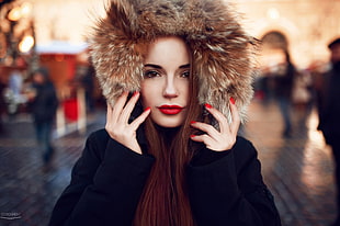 selective focus photography of woman wearing fur hoodie