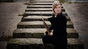 woman holding saxophone