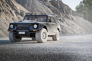 black off-road vehicle on gravel during daytime HD wallpaper