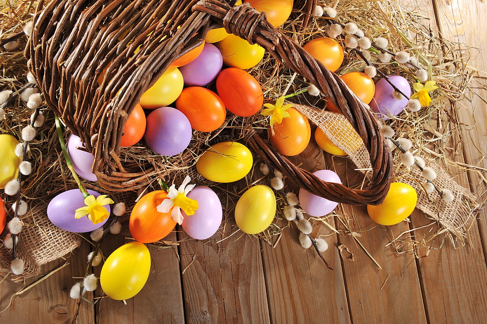 assorted-color Easter egg lot and brown wicker basket HD wallpaper