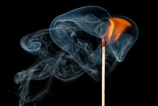wooden stick with fire and smoke