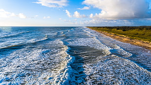 green grass field, sky, clouds, sea, waves