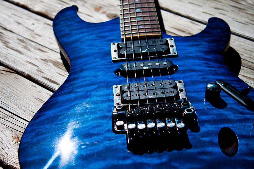 blue electric guitar on wooden surface HD wallpaper