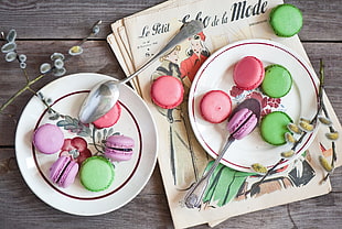 assorted colors of French macaroons on plate HD wallpaper