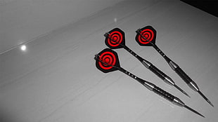three black darts, red, pins, darts, selective coloring