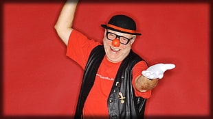 man in red shirt, black leather vest, and white gloves costume