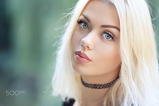 selective focus photography of woman wearing black choker necklace