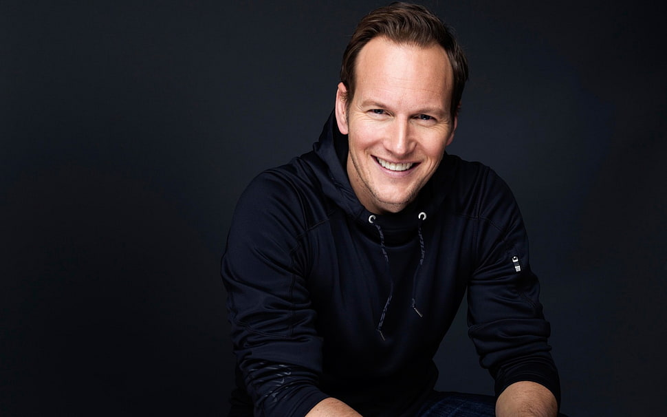 man wearing blue pullover hoodie smiles HD wallpaper