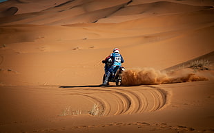 man riding on dirt bike on desert